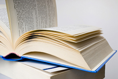 A picture of an open book sitting on a table.