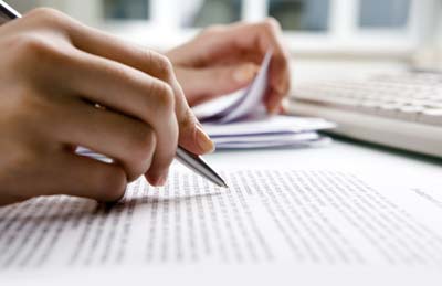 A picture of someone editing a paper.